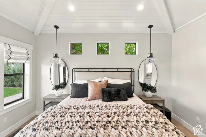Vaulted plank ceiling, exposed beams, recessed lighting, and wood-finish flooring