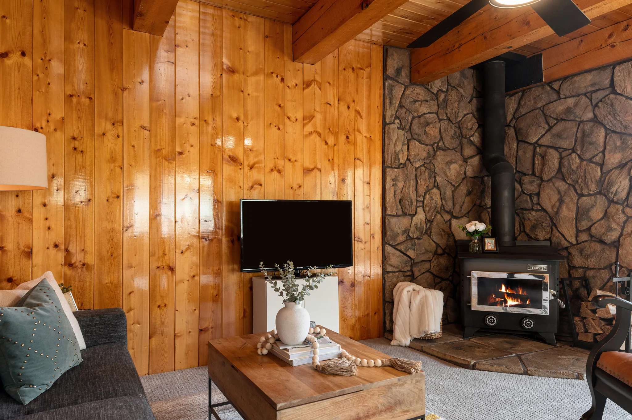 Wood-paneled wall and wood-beam ceiling