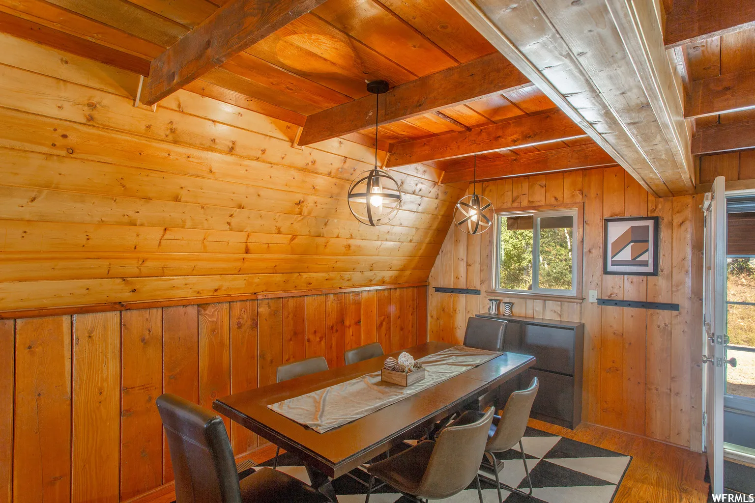 Wood paneling throughout, exposed wood beams, and a built-in window