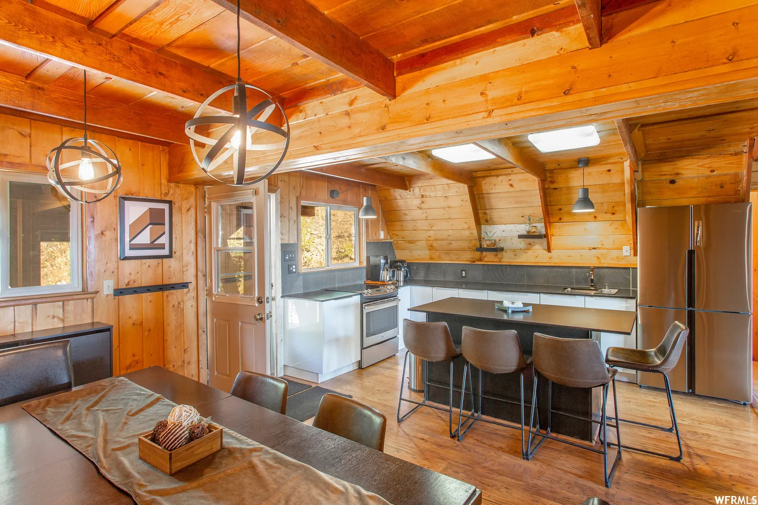 Wood-paneled interior featuring exposed ceiling beams and wood-finish flooring