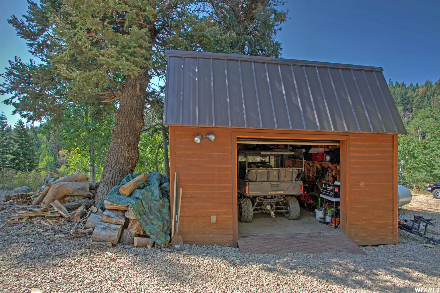 Wood-sided detached garage with a dark metal roof