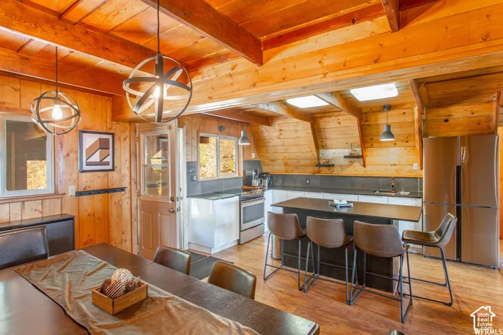Wood-paneled interior featuring exposed ceiling beams and wood-finish flooring