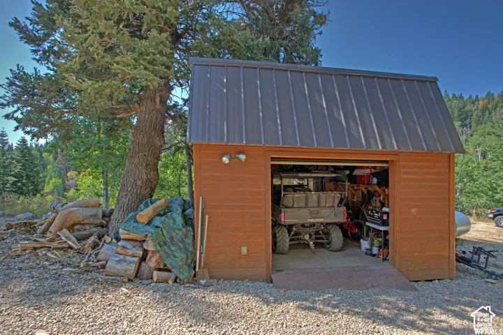 Wood-sided detached garage with a dark metal roof