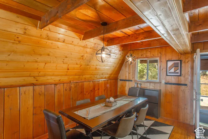 Wood paneling throughout, exposed wood beams, and a built-in window