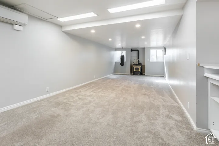 Recessed ceiling lighting, flush-mounted ceiling lighting, built-in shelving, light gray wall finishes, and light-toned carpet