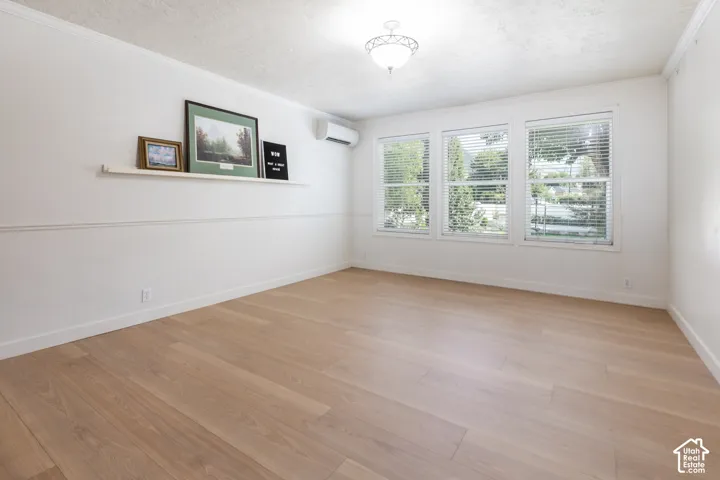Light wood-finish flooring with white baseboards
