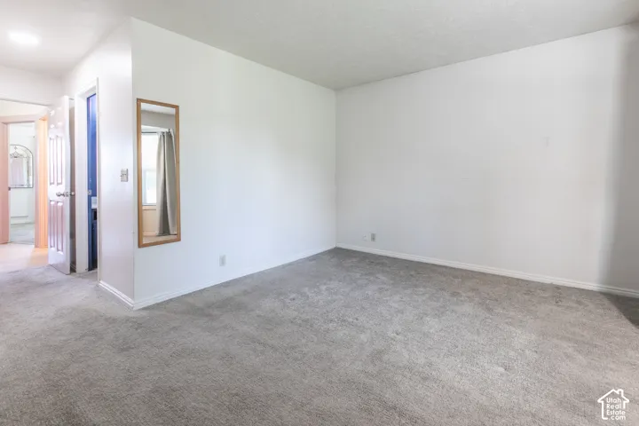 Neutral tone wall paint, gray carpeting, and white trim