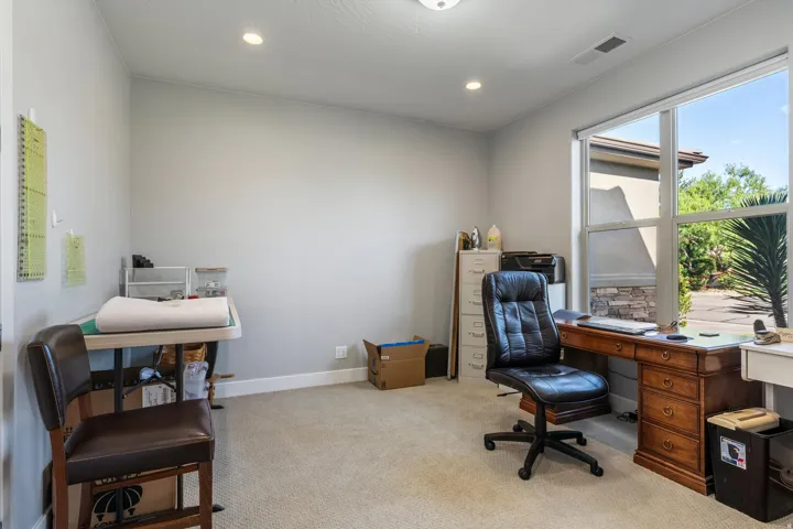 Recessed ceiling lighting, large window, and light-toned wall paint