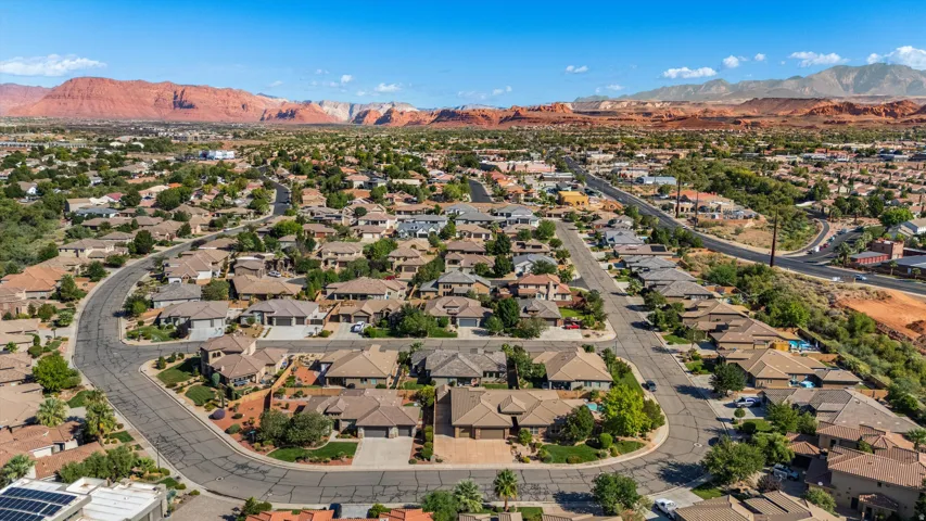 Residential neighborhood with a curved street layout, mature landscaping, and diverse home styles