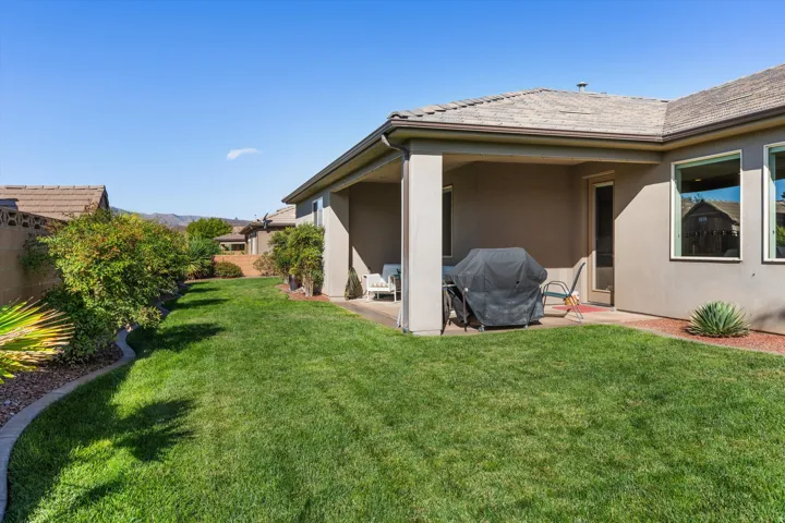 Expansive manicured lawn with mature shrubbery