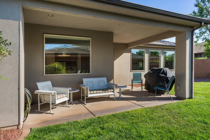 Covered patio with concrete flooring, recessed lighting, and a large window