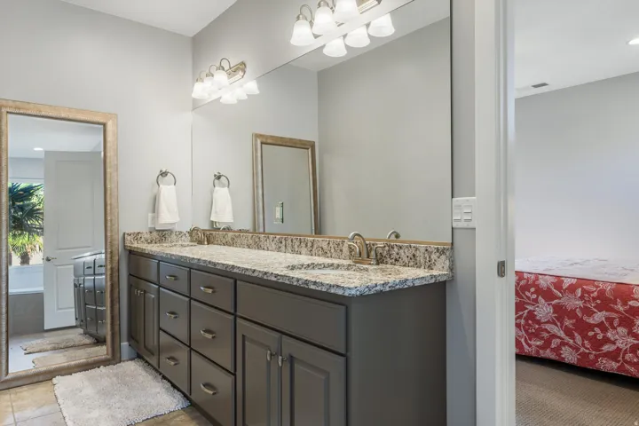Double vanity with granite countertop, dual undermount sinks, and brushed nickel fixtures