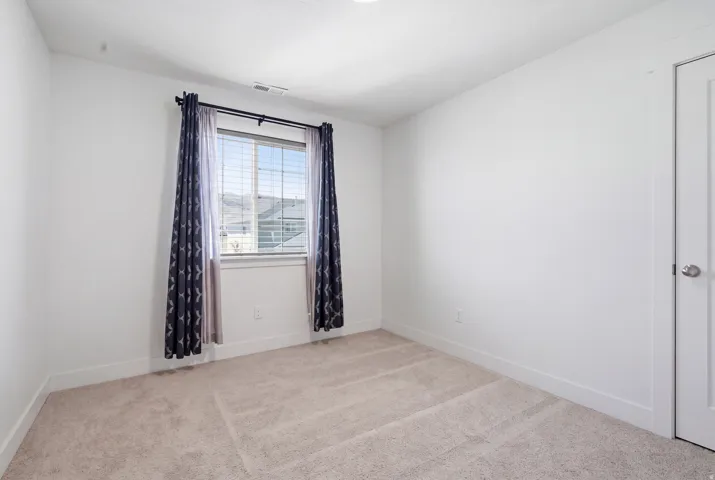 Plush carpet flooring complements bright white walls