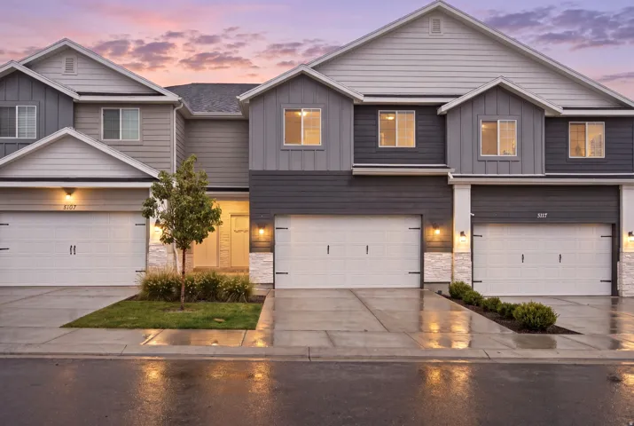 Multi-level exterior with mixed siding and stone accents