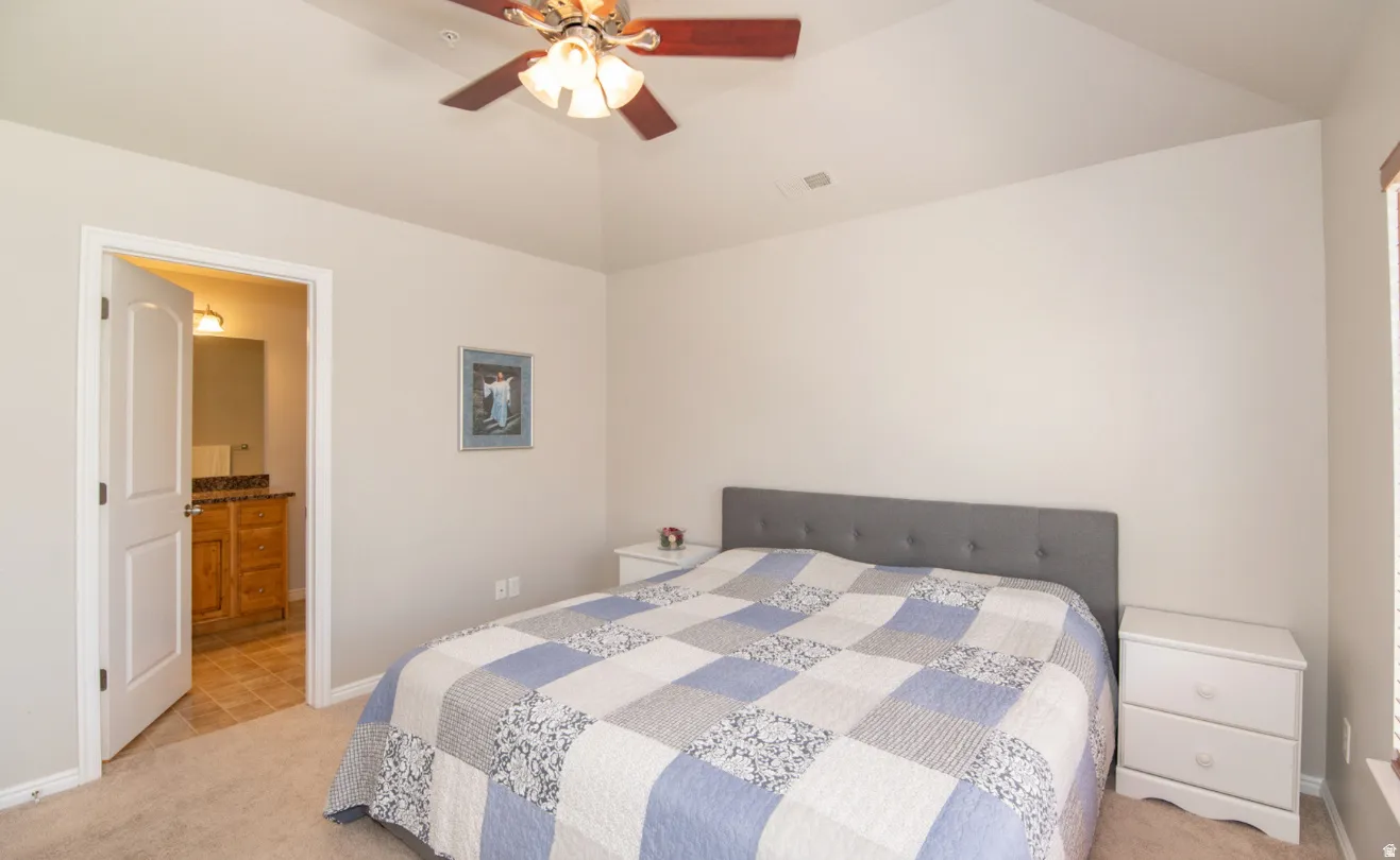 Vaulted ceiling featuring a ceiling fan with integrated lighting