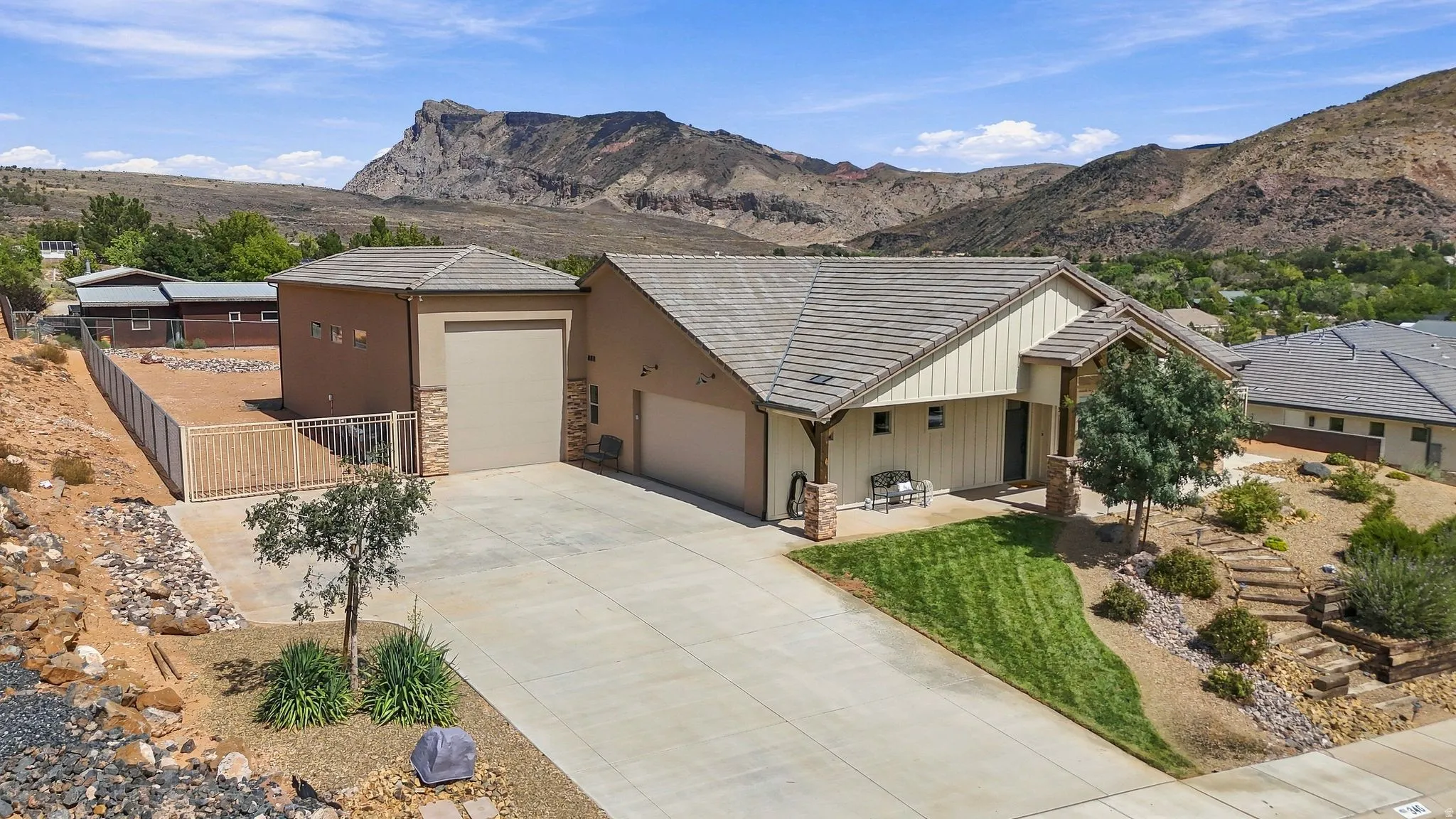 Attached garage and separate RV garage, concrete driveway, and a front entry with a covered porch