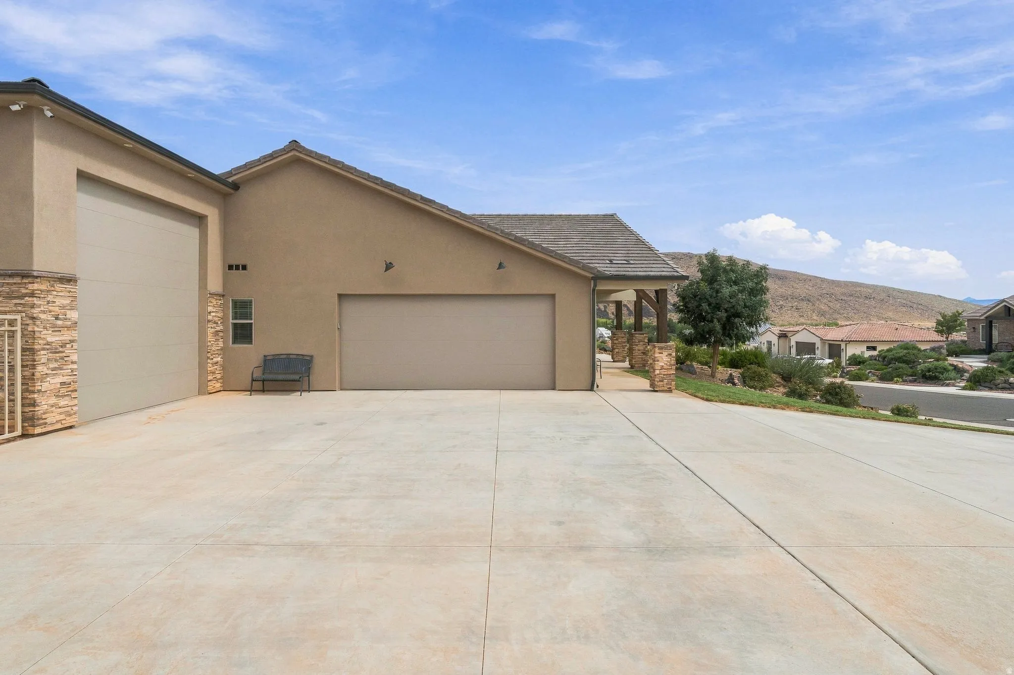 Smooth concrete driveway with dual garage doors