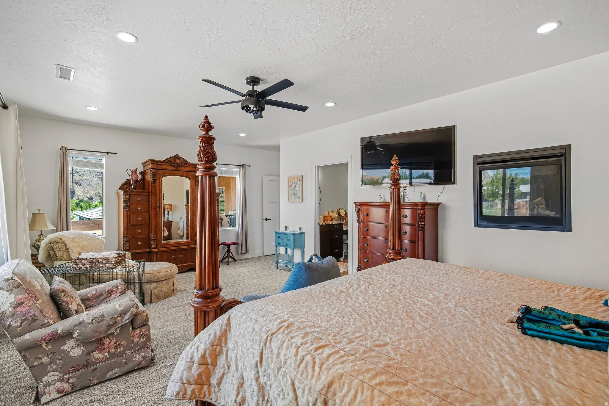 Recessed lighting, ceiling fan, multiple windows, and a built-in electric fireplace