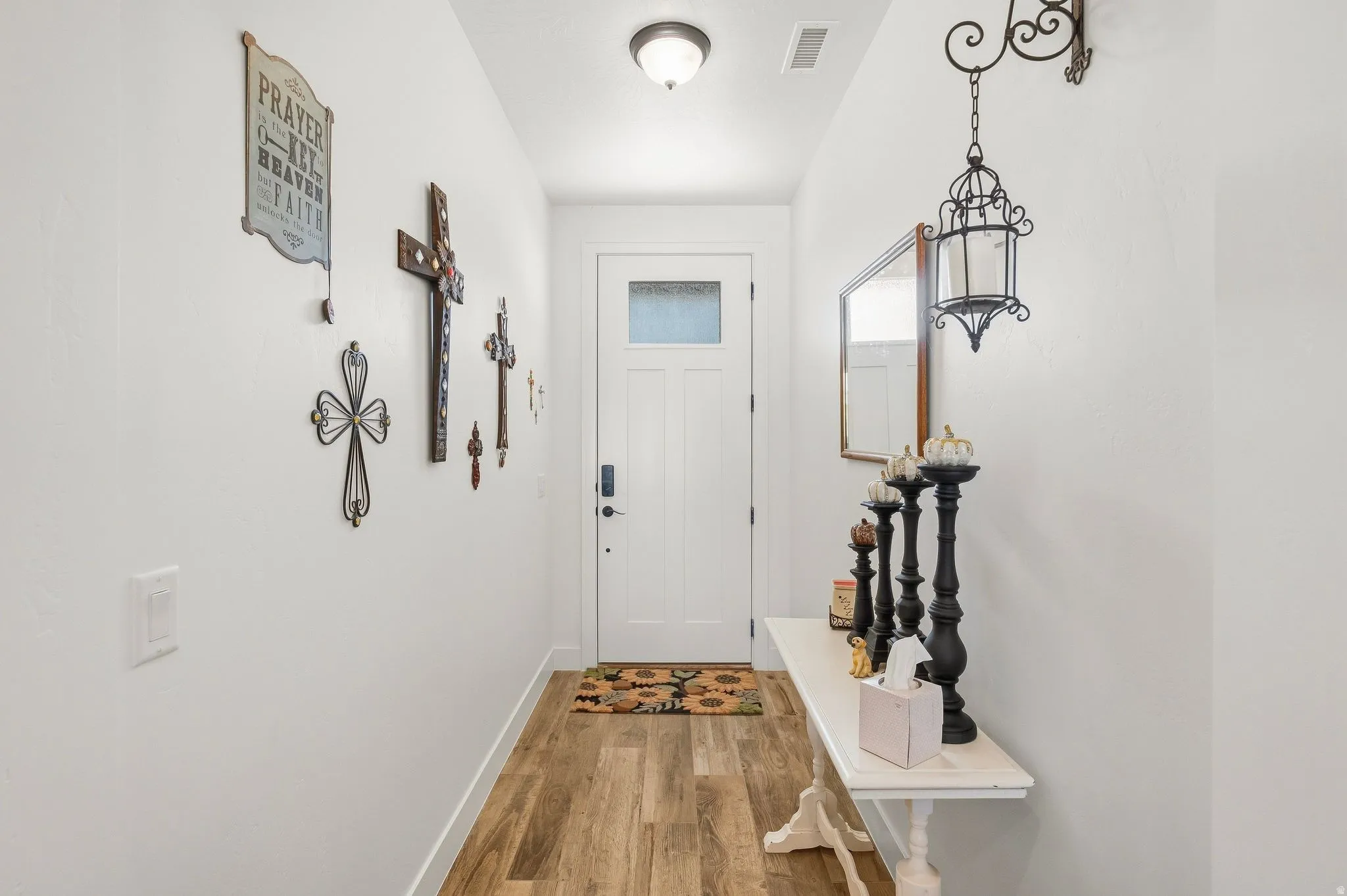Entryway featuring a white paneled door with frosted glass, wood-finish flooring, and a flush-mount ceiling light
