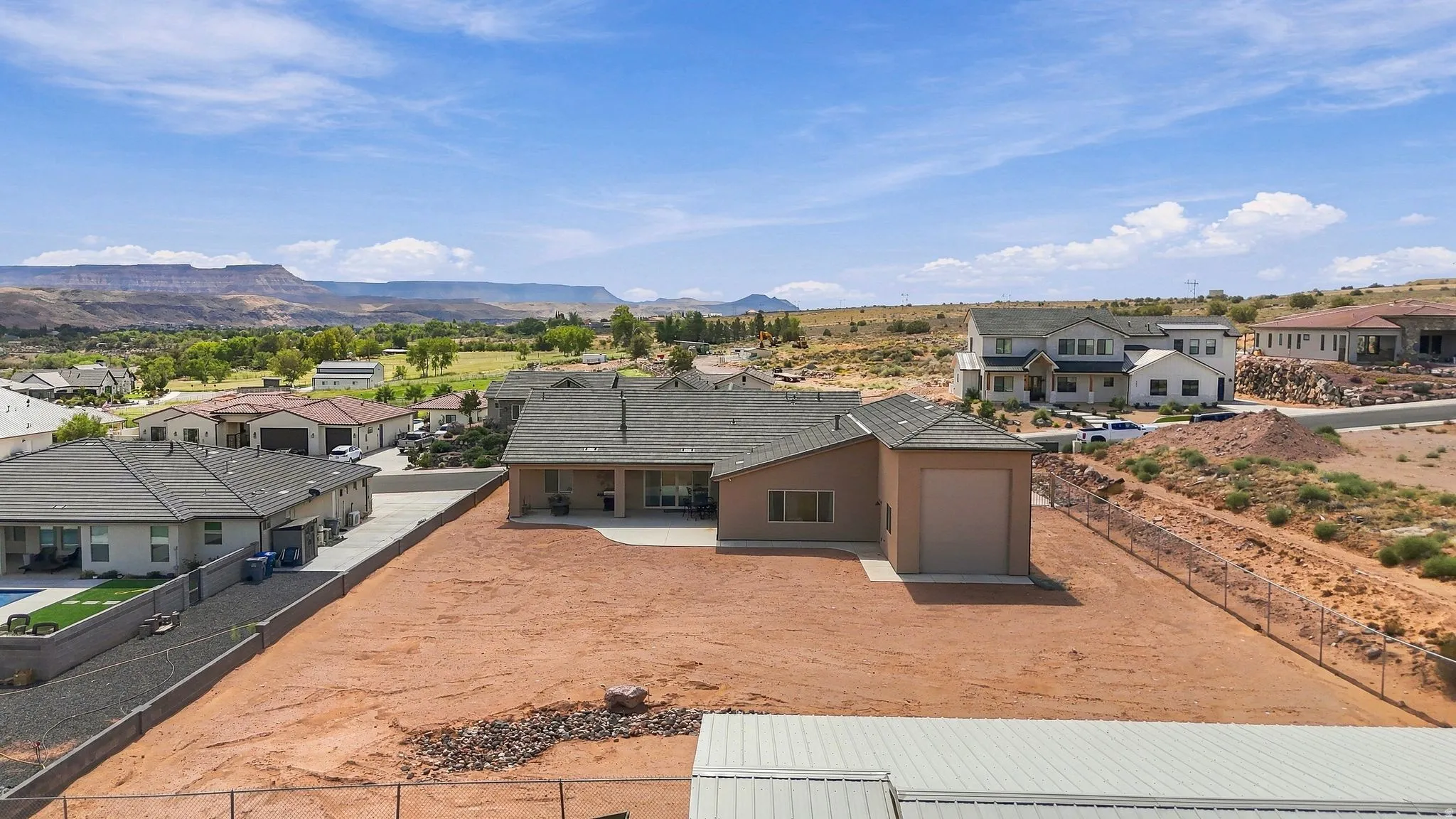 Single-story residence featuring an attached garage and a rear patio with an extended concrete pad