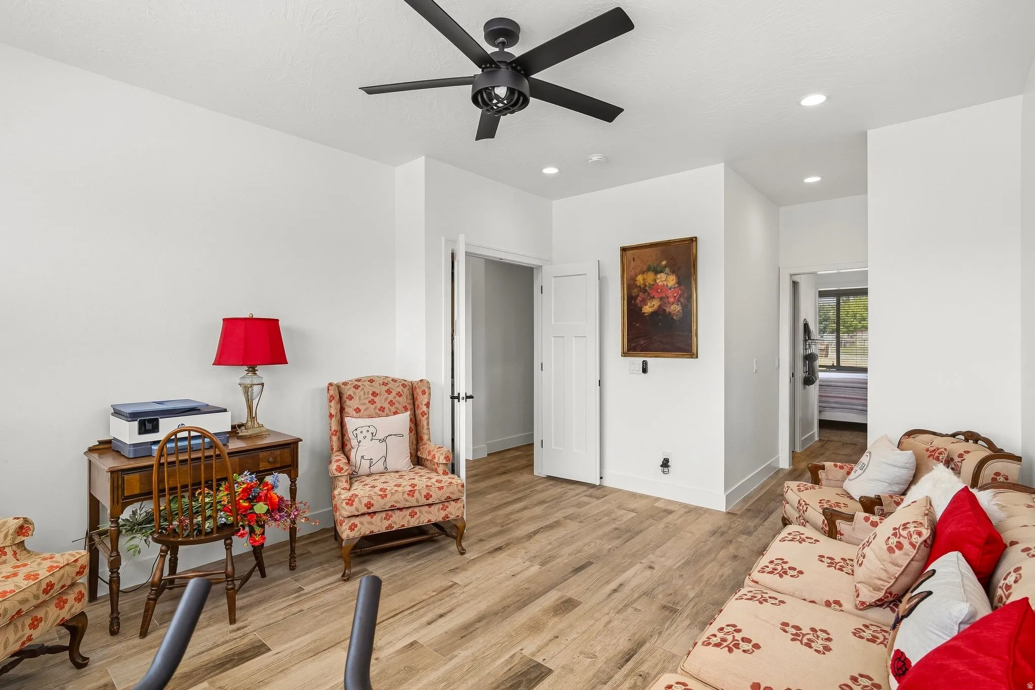 Wood-finish flooring, recessed lighting, white walls, and a contemporary ceiling fan