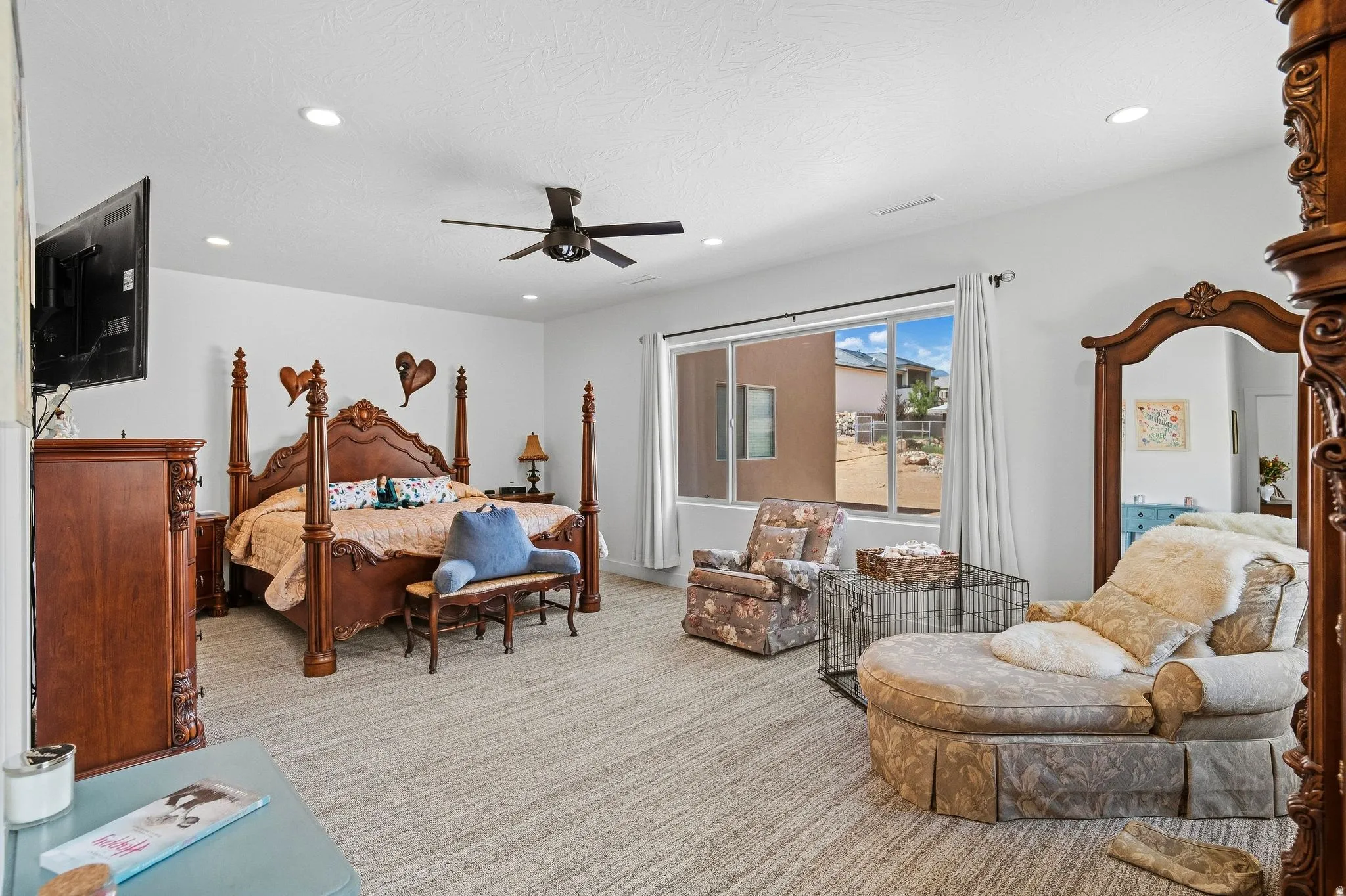 Recessed lighting, ceiling fan, carpet flooring, and a large window