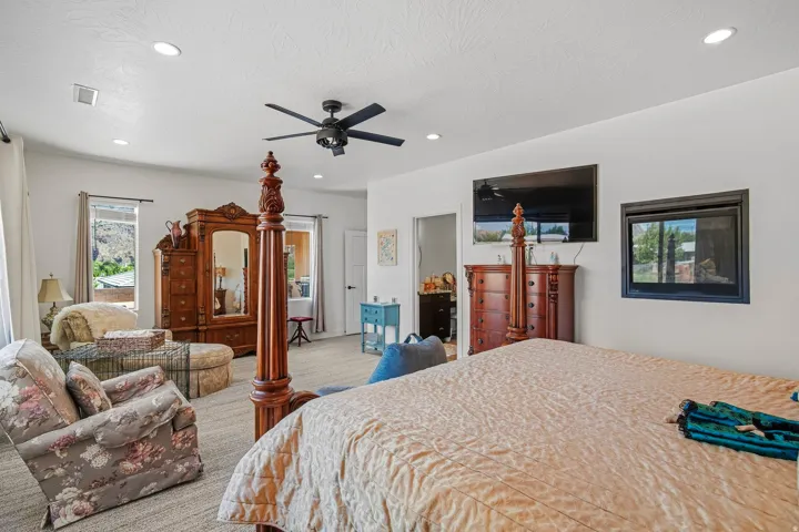 Recessed lighting, ceiling fan, multiple windows, and a built-in electric fireplace