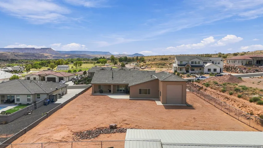 Single-story residence featuring an attached garage and a rear patio with an extended concrete pad