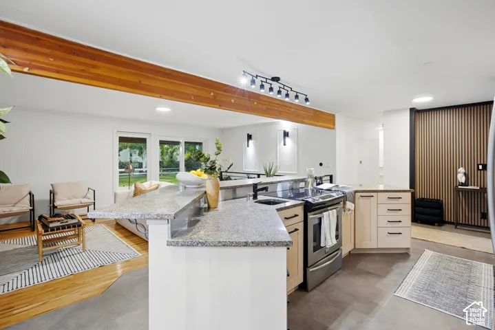 Kitchen featuring light-toned cabinetry, stainless steel appliances, and granite countertops