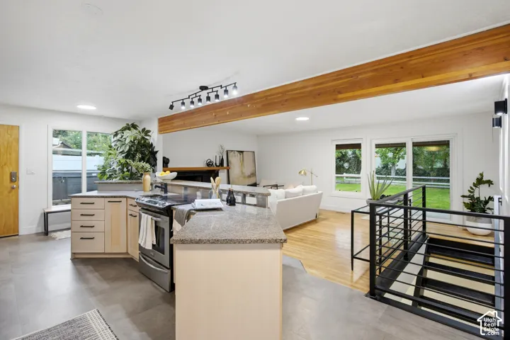 Kitchen featuring granite countertops, stainless steel appliances, and light wood-finish cabinetry