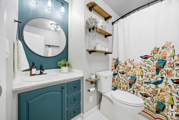 Built-in vanity with teal cabinetry and white countertop