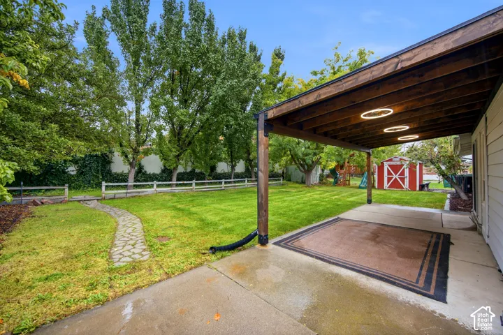Covered patio with recessed lighting, concrete flooring, and a grass lawn
