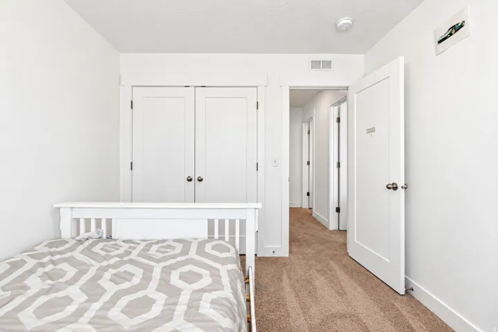 Neutral carpeting, solid core doors, and a built-in closet with double doors
