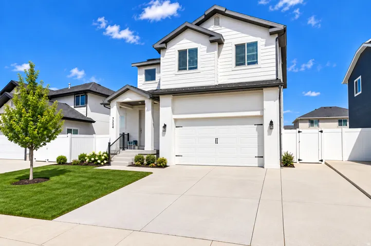 Modern two-story residence with white siding and dark trim