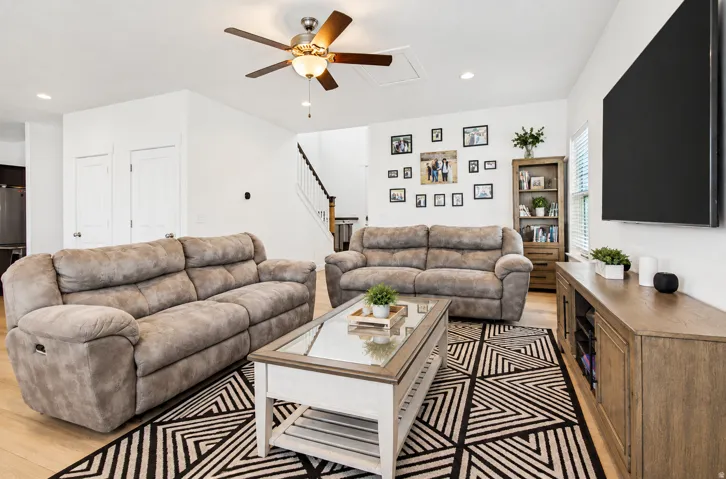Recessed lighting, ceiling fan, wood-finish flooring, and a built-in staircase
