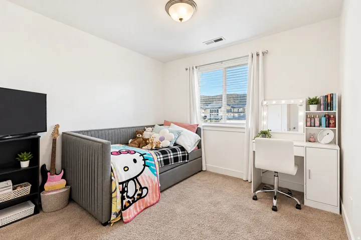 Carpeted room featuring a window with white blinds and white trim, white walls, and a built-in ceiling light fixture