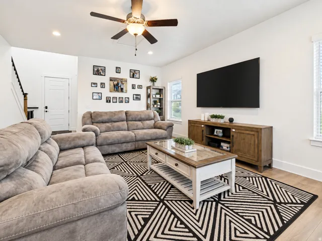Recessed lighting, wood-finish flooring, ceiling fan, and white trim