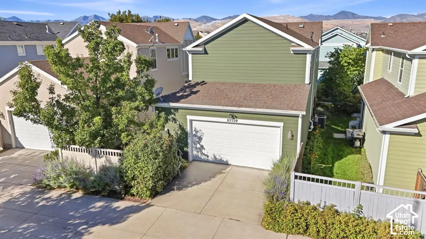 Two-story residence with green siding and white trim