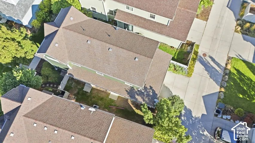 Brown-shingled rooftops with multiple skylights and varying architectural angles
