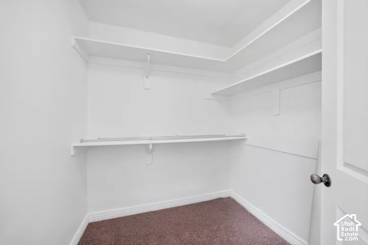 Walk-in closet with integrated shelving and hanging rods