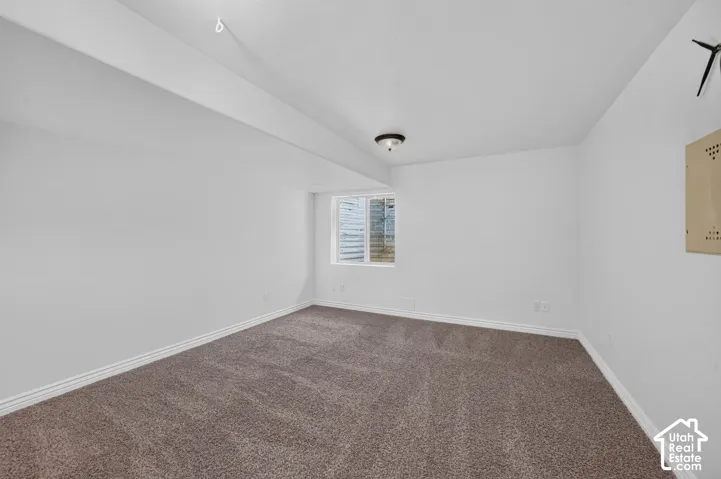 Wall-to-wall carpeting with a neutral finish, white painted walls, and a ceiling-mounted light fixture