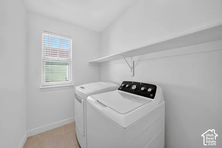 Recessed window with blinds, overhead shelving, and tile flooring