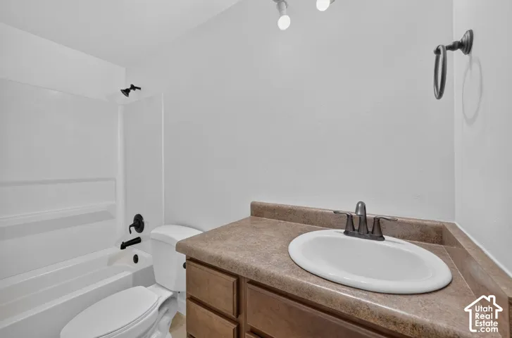 White bathtub and shower surround with matte black fixtures