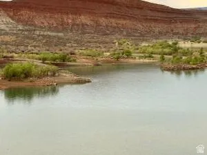 Quail Lake looking North West .Expansive water feature with natural rock formations and a desert mountain backdrop