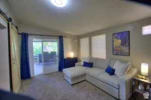 The living room sliding glass doors open to the back deck gathering area which faces west.