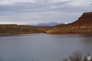 Quail Lake looking to the East viewing part of Zion National Park.  Waterfront setting featuring distant mountains and natural rock formations