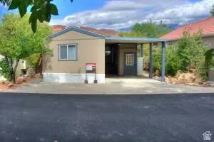 Front of the home showing the Red cliffs to the west behind the home.