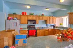 Kitchen featuring wood-finish cabinetry, built-in microwave, and a window