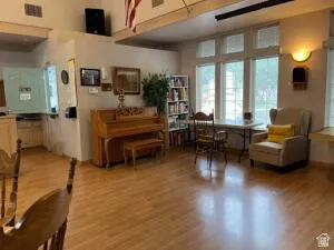 Wood-finish flooring throughout, complemented by expansive windows offering natural light.  Group gathering for singing and programs.