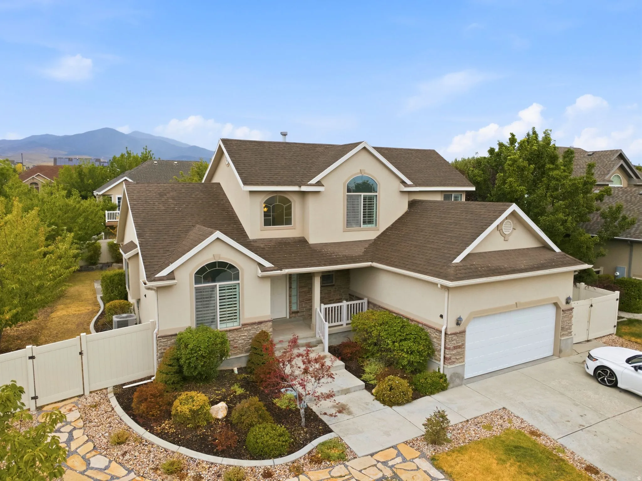 Stucco exterior with stone accents and a two-car garage